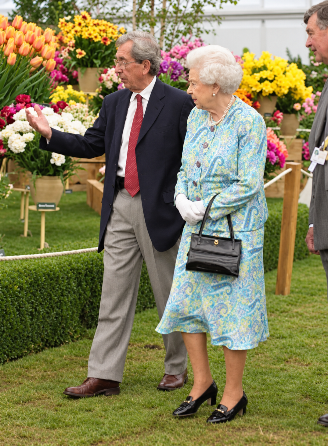 Ronald Blom showing Queen Elizabeth II the Bloms display at a past Chelsea Flower Show